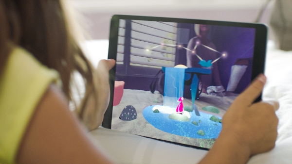 Girl using Wonderscope AR app on tablet